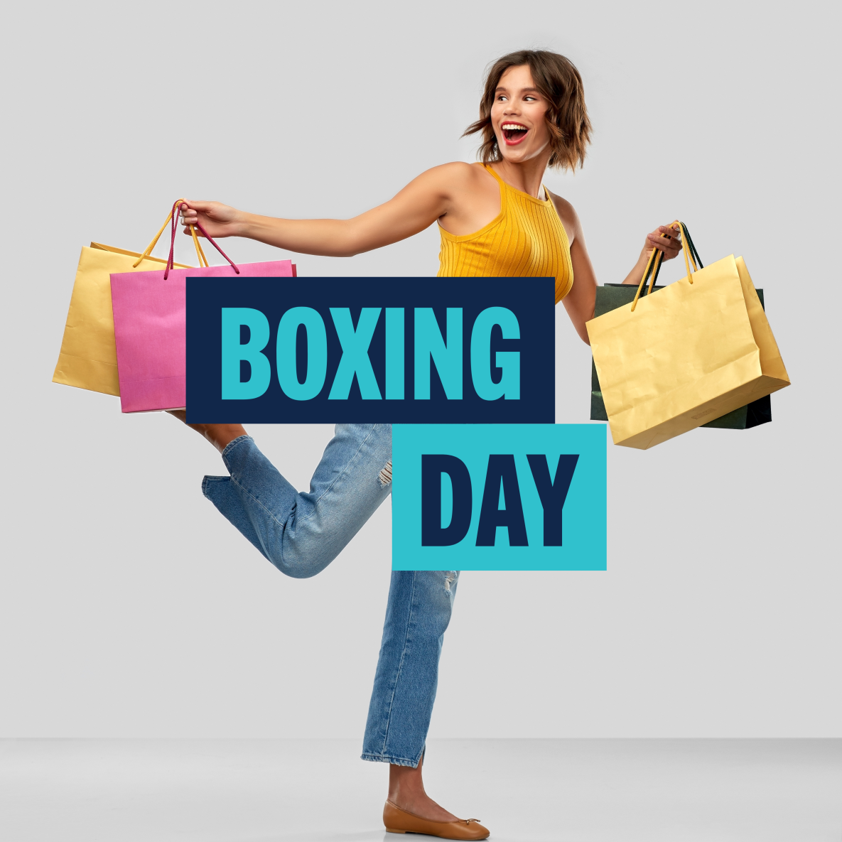 Woman holding shopping bags with Boxing Day